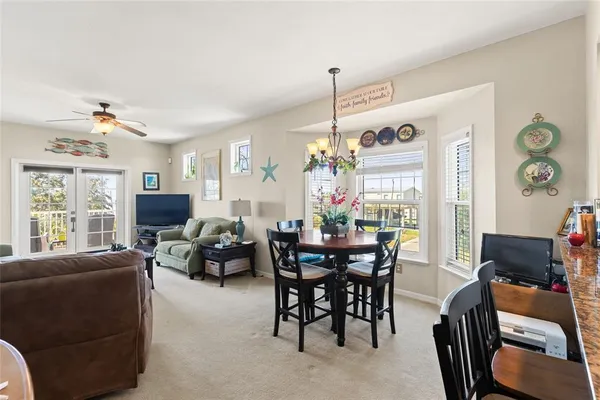 a living room with furniture a chandelier and a flat screen tv