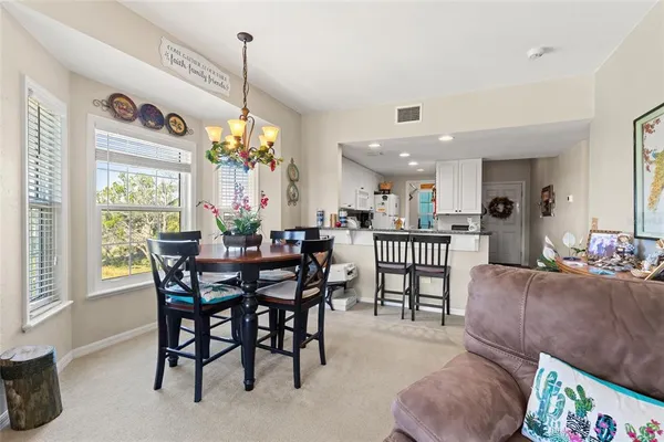 a view of a dining room and livingroom with furniture window and wooden floor