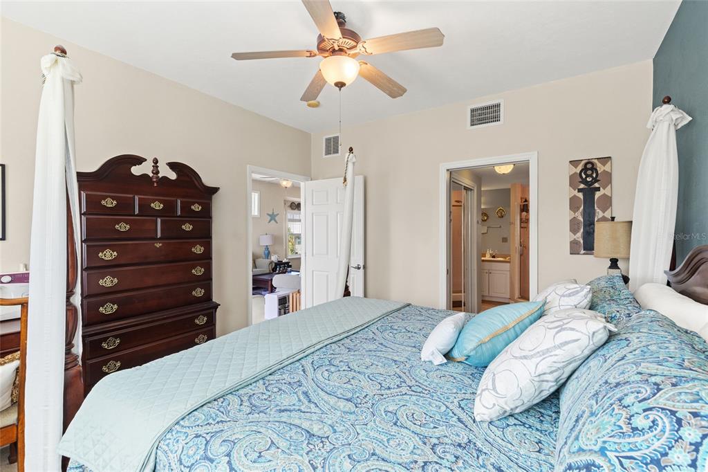 502 Main Street, Unit 112 Horseshoe Beach, FL 32648 - Photo 19 of 45 a bedroom with a bed a chandelier and a dresser
