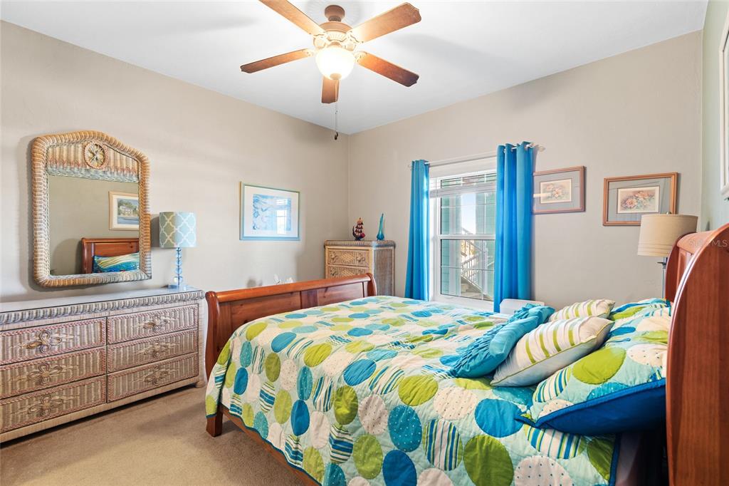 502 Main Street, Unit 112 Horseshoe Beach, FL 32648 - Photo 23 of 45 a bedroom with a bed and a chandelier