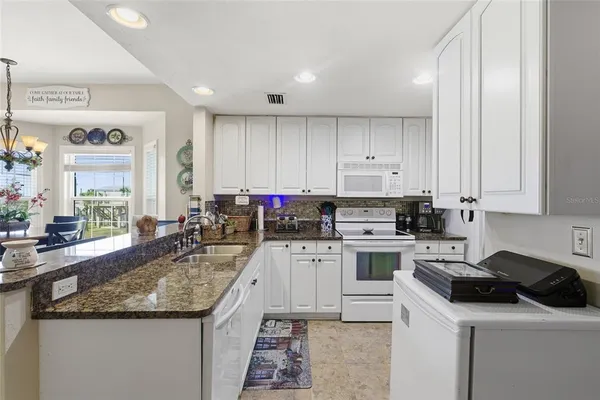 a kitchen with a stove sink and cabinets