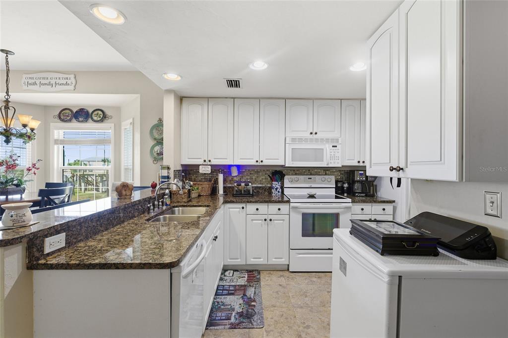 502 Main Street, Unit 112 Horseshoe Beach, FL 32648 - Photo 7 of 45 a kitchen with a stove sink and cabinets