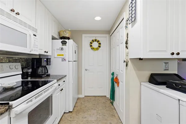 a kitchen with stainless steel appliances granite countertop a refrigerator and a stove
