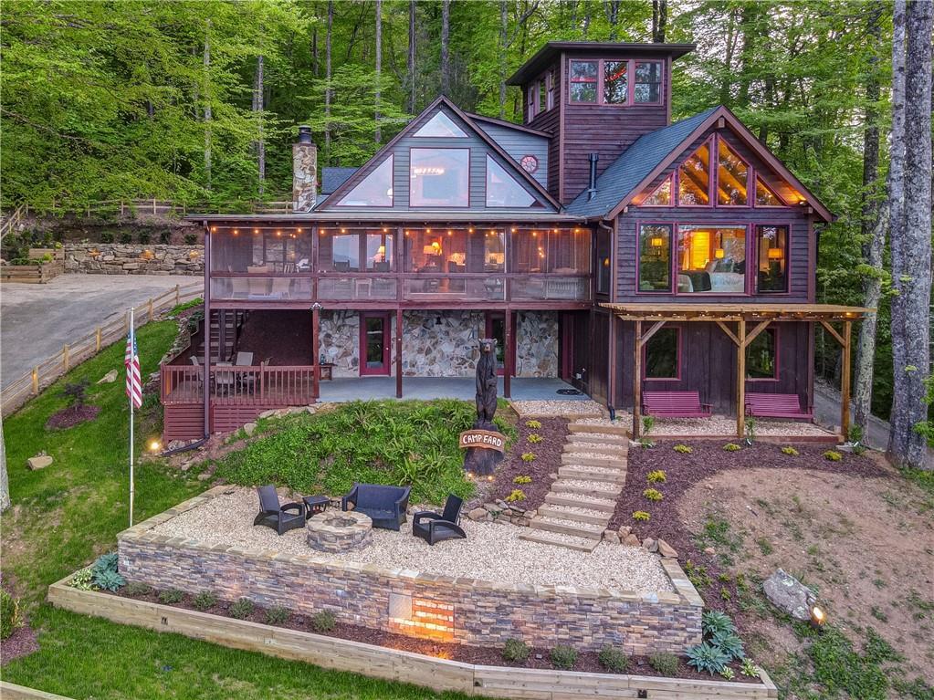 Undisclosed Address Blue Ridge, GA 30513 - Photo 1 of 51 a front view of a residential apartment building with a yard and potted plants