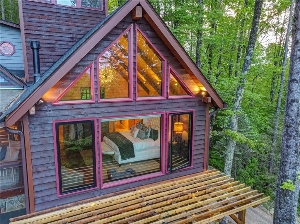 Undisclosed Address Blue Ridge, GA 30513 - Photo 11 of 51 a view of backyard with large trees and a wooden fence