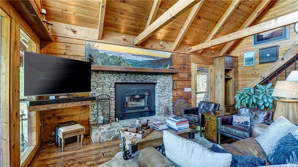 Undisclosed Address Blue Ridge, GA 30513 - Photo 13 of 51 a living room with furniture a flat screen tv and a fireplace