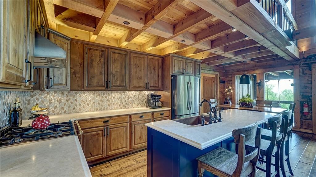 Undisclosed Address Blue Ridge, GA 30513 - Photo 17 of 51 a kitchen with a sink a stove and chairs