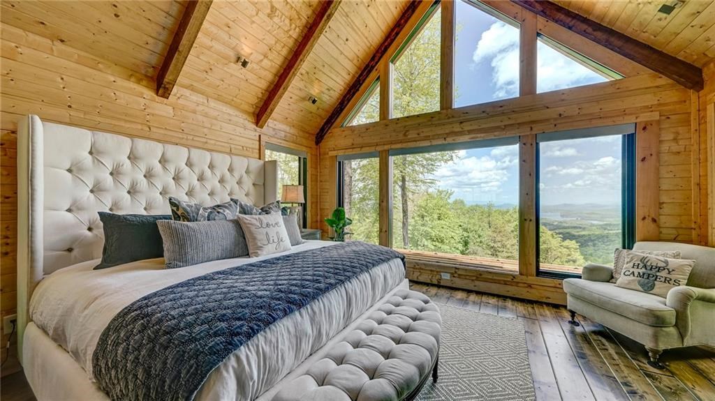 Undisclosed Address Blue Ridge, GA 30513 - Photo 21 of 51 a bed sitting in a bedroom next to a large window