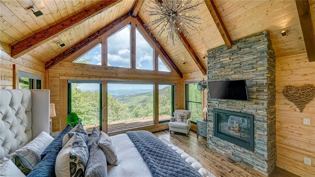 Undisclosed Address Blue Ridge, GA 30513 - Photo 23 of 51 a living room with furniture a flat screen tv and a fireplace