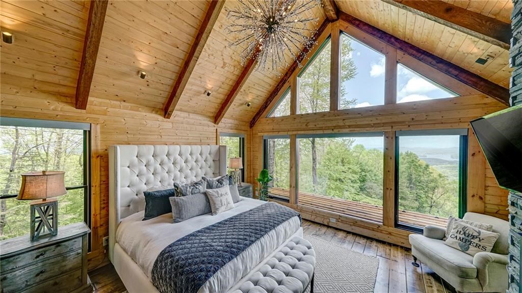 Undisclosed Address Blue Ridge, GA 30513 - Photo 24 of 51 a bedroom with a bed and a large window