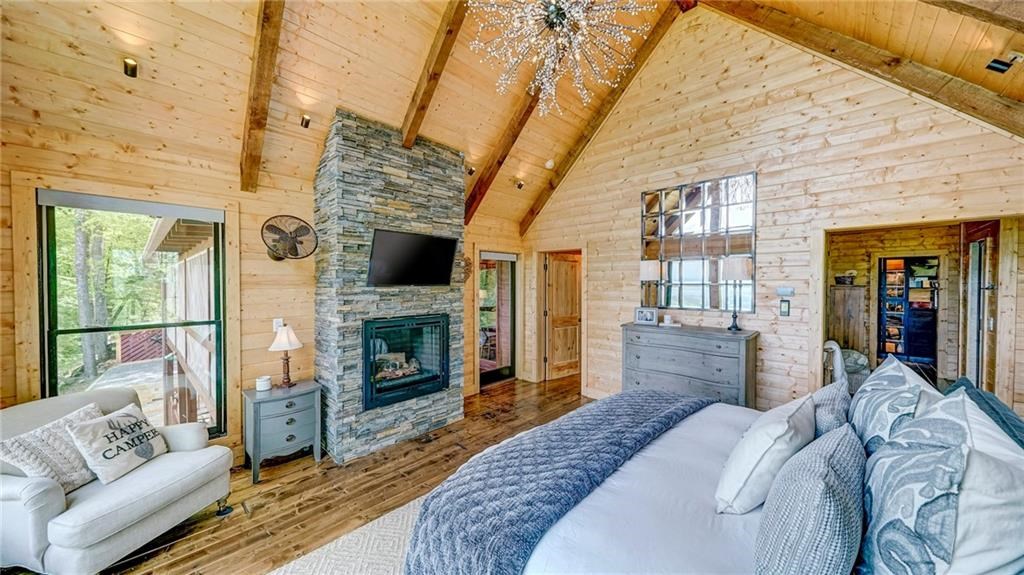 Undisclosed Address Blue Ridge, GA 30513 - Photo 25 of 51 a bed room with furniture and a fireplace