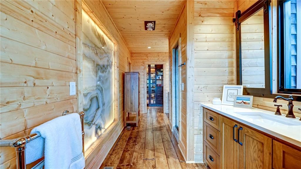 Undisclosed Address Blue Ridge, GA 30513 - Photo 26 of 51 a bathroom with a sink a mirror and a shower