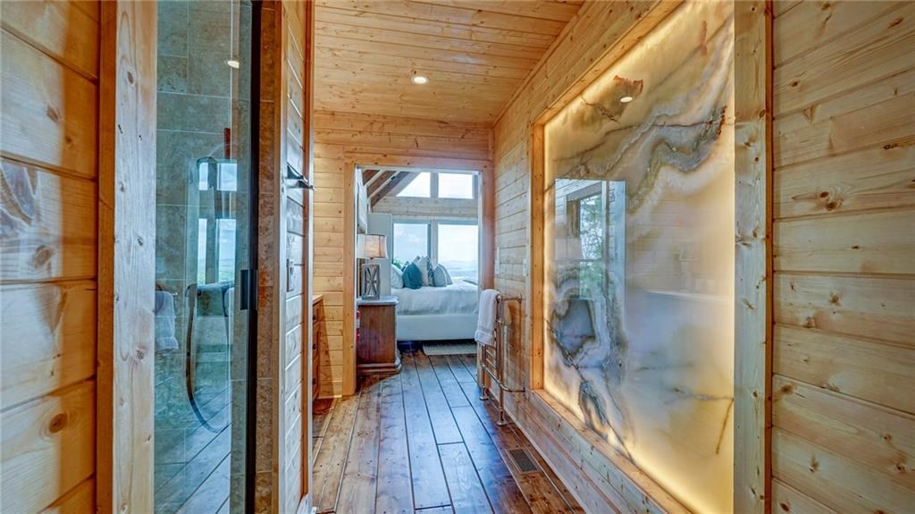 Undisclosed Address Blue Ridge, GA 30513 - Photo 27 of 51 a bathroom with a glass door shower and a mirror