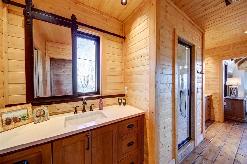 Undisclosed Address Blue Ridge, GA 30513 - Photo 37 of 51 a bathroom with a double vanity sink and a mirror