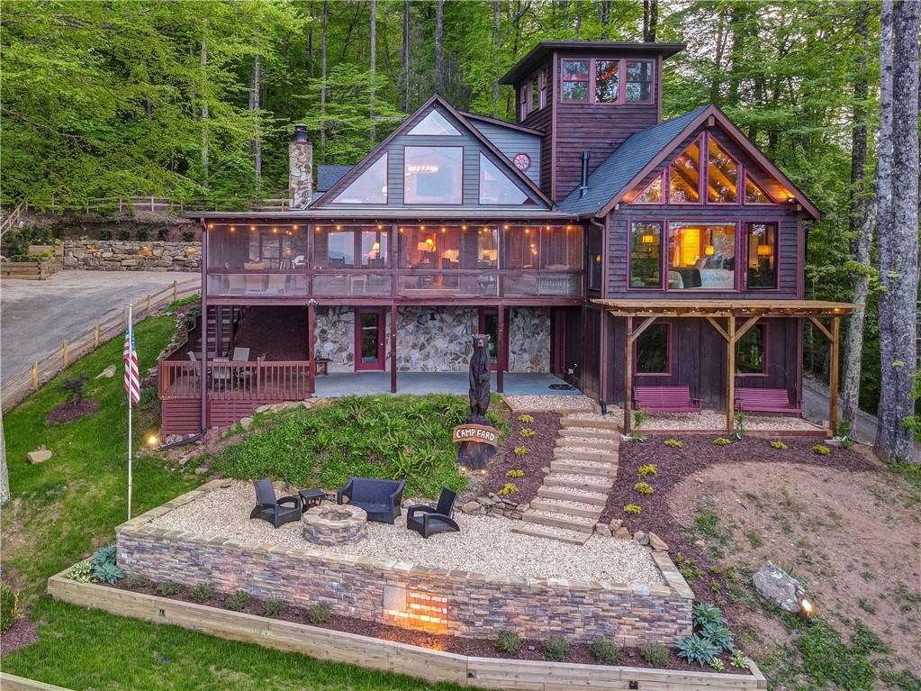Undisclosed Address Blue Ridge, GA 30513 - Photo 51 of 51 a front view of a residential apartment building with a yard and potted plants
