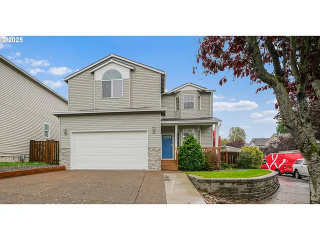 a front view of a house with a yard and garage