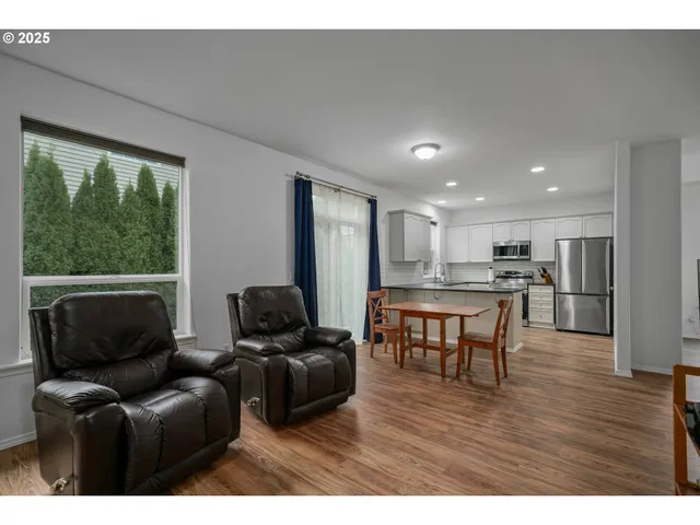 a living room with furniture and kitchen view