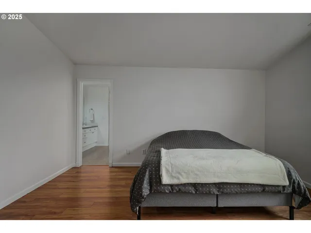 a bedroom with a bed and a night stand