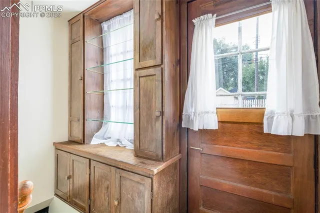 a bathroom with a granite countertop sink and a window