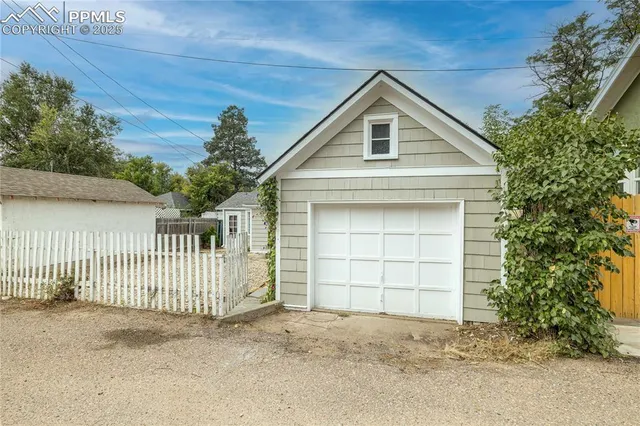 a view of backyard of house with green space
