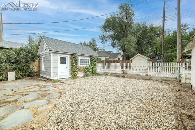 an aerial view of a house with a yard and potted plants
