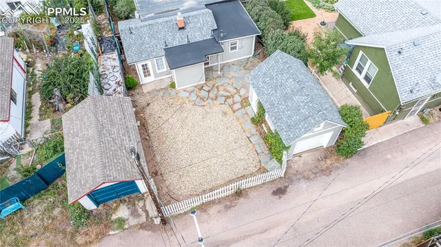 an aerial view of a house with a yard and parking