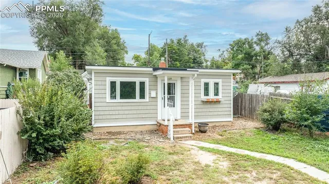 a view of house with backyard