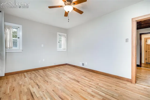 wooden floor in an empty room with a window