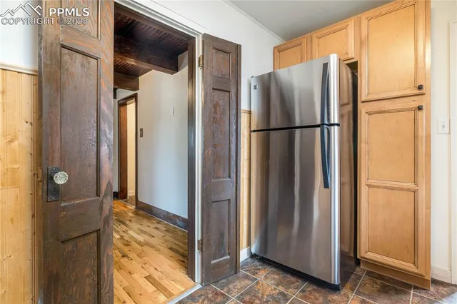 a view of kitchen with a refrigerator and a table