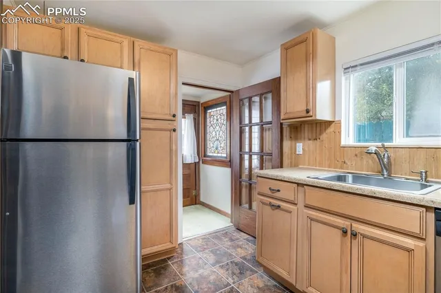 a white refrigerator freezer sitting inside of a kitchen