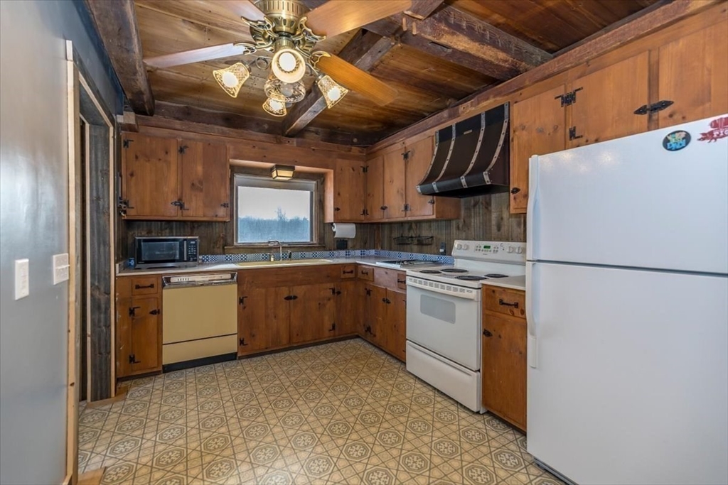 1083 Mt Elam Road Leominster, MA 01420 - Photo 9 of 30 a kitchen with a refrigerator a stove a sink and cabinets