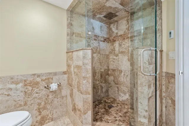 a bathroom with a shower and toilet