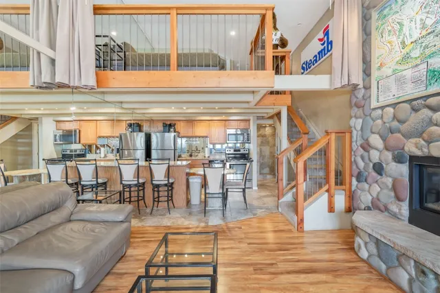 a living room with furniture a rug and a floor to ceiling window