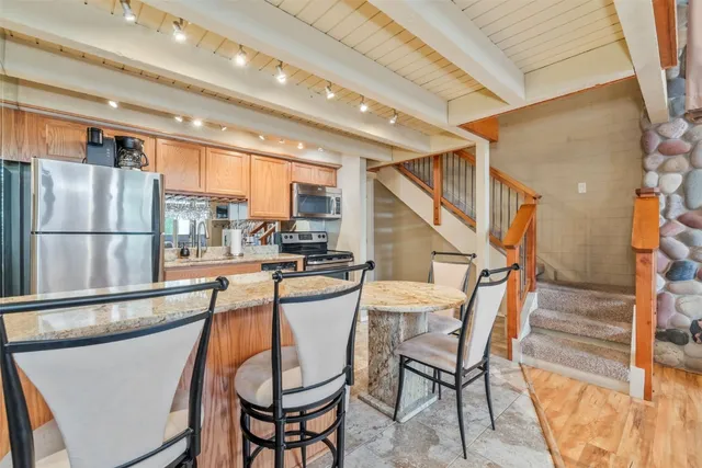 a dining room with furniture and a floor to ceiling window