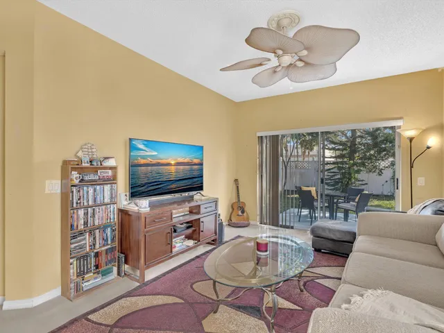 a kitchen with a refrigerator and table chair