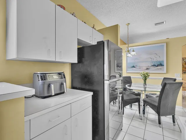 a bedroom with a large bed a chandelier and closet