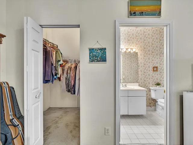 an empty room with a fan & a window