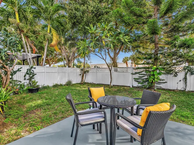 a view of a house with backyard porch and sitting area