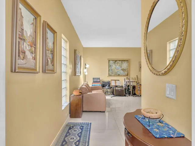 a kitchen with white cabinets and dining table