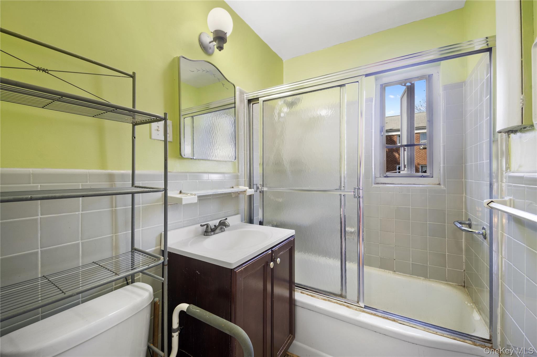 226-29 Manor Road, Unit UPPR Queens, NY 11427 - Photo 19 of 21 Bathroom featuring vanity, shower / bath combination with glass door, and tile walls