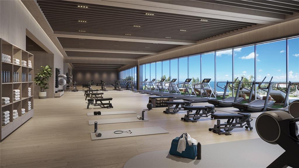 668 Quay Commons, Unit 102 Sarasota, FL 34236 - Photo 8 of 11 a room with gym equipment and a large window