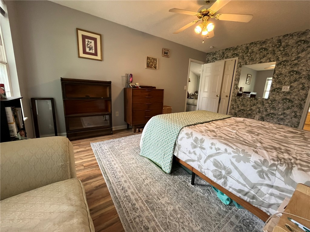 116 Arbors Court Central, SC 29630 - Photo 15 of 27 A well-lit bedroom featuring durable wood flooring and a classic ceiling fan.