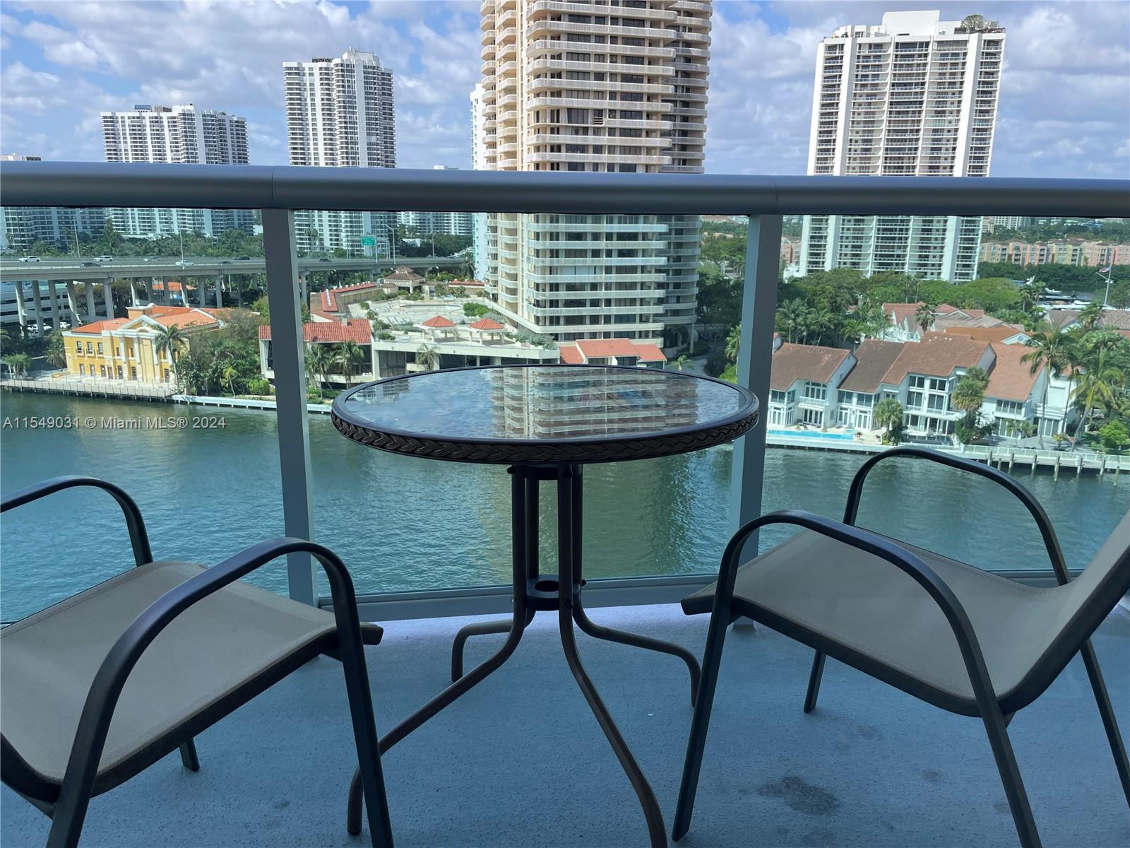 a two chairs and a table in a balcony