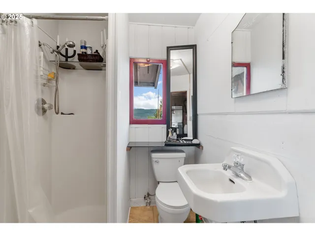 a bathroom with a sink and mirror with toilet