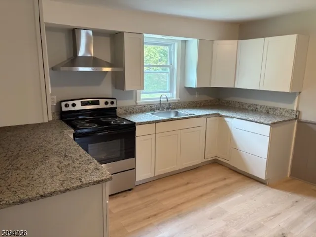 a kitchen with a sink stove and cabinets