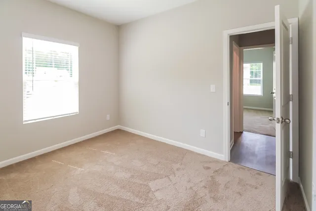 an empty room with windows and closet