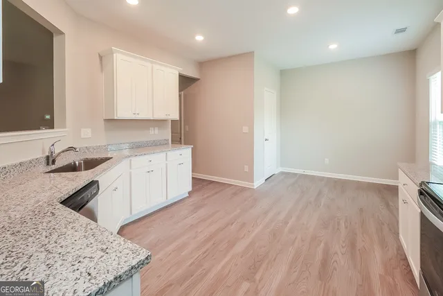 a kitchen with a sink stove and cabinets