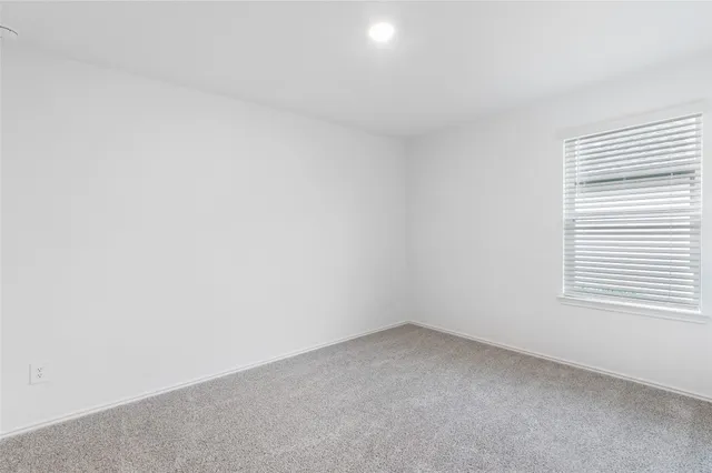 a view of an empty room and a window