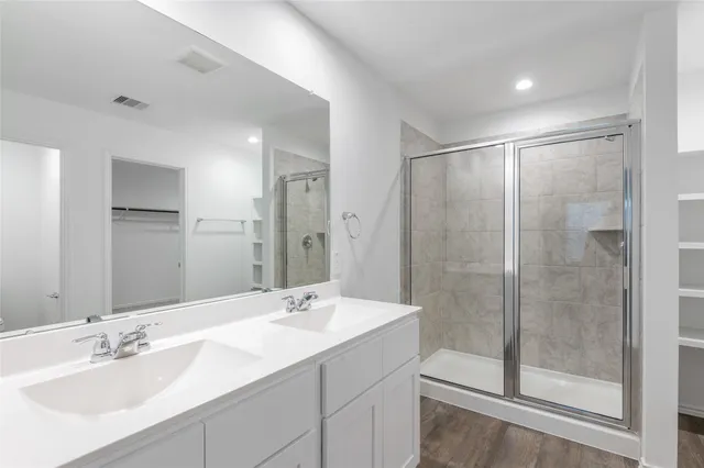 a bathroom with a shower sink and mirror