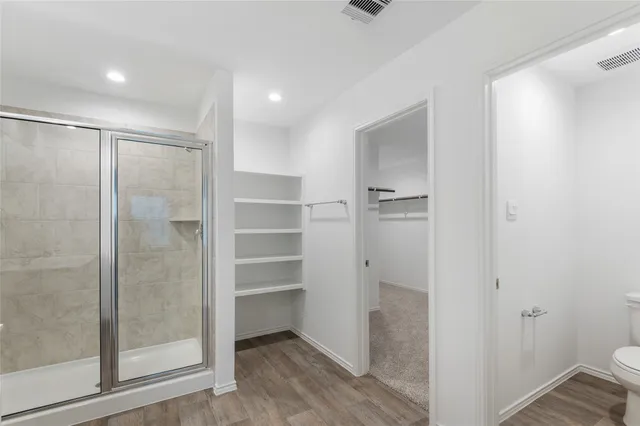 a bathroom with a shower and a glass door